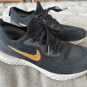 Nike women’s epic react fly knit, black and gold. 8.5